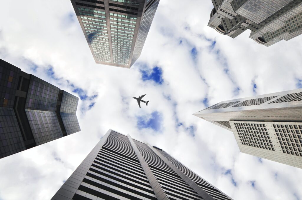 An airplane viewed through skyscrapers.