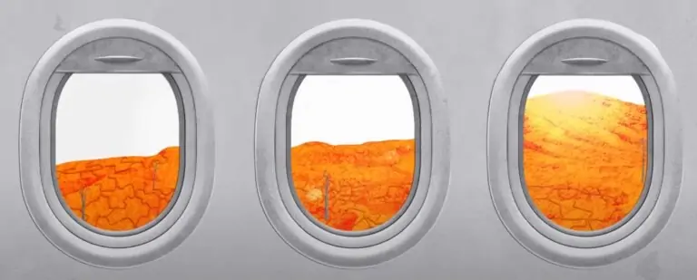 Airplane window on desolate landscape