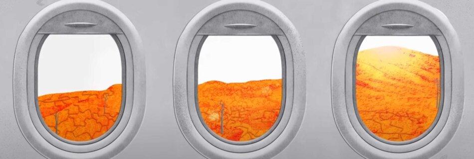 Airplane window on desolate landscape