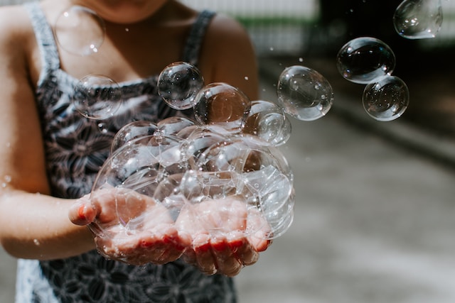 Girl holding soap bubbles