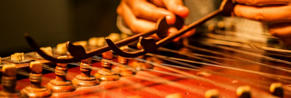 A person playing the santoor